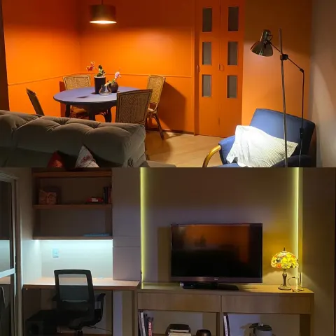 Ambiente integrado com sala de jantar, sala de estar e home office com TV